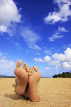 Sandy feet on a tropical beach