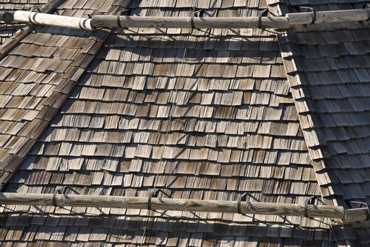 Detail of old wooden roof with snow guards trunk - Friuli Italy