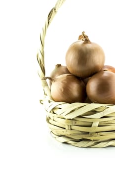 Ripe golden onionsin basket on white background.