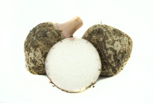 fresh taro root or Colocasia on a white background