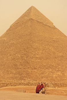 Camel resting near Pyramid of Khafre during sand storm, Cairo, Egypt