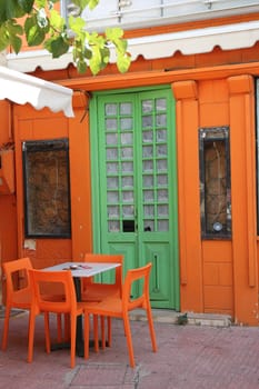 old green door on an orange wall