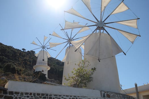 traditional Greek windmilsl against the blue sky