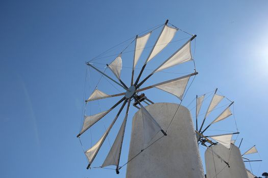 traditional Greek windmilsl against the blue sky
