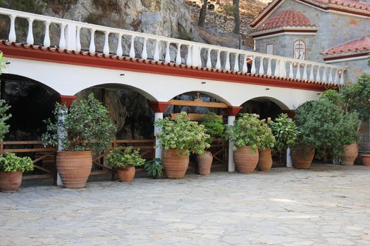 monastery courtyard surrounded by mountains and plants