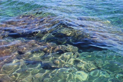 sea bottom through the clear water and the sun's rays