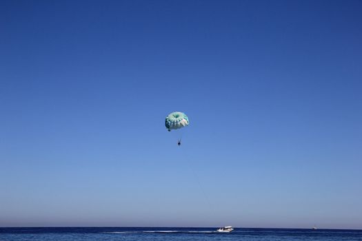 boat floating on the sea with a parachute























