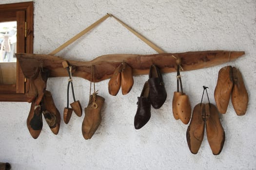 shoe lasts hanging on the wall in the workshop