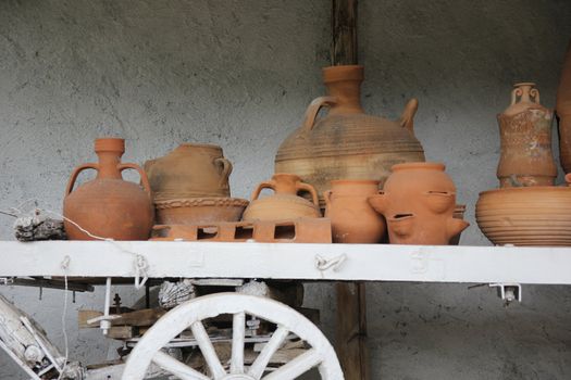 vintage cart with pottery under a canopy























