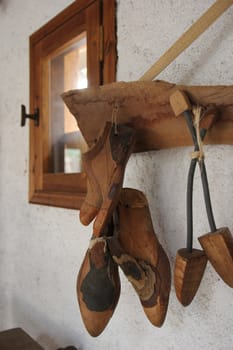 shoe lasts hanging on the wall in the workshop
