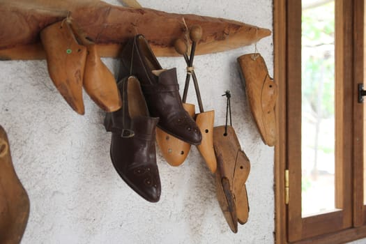 shoe lasts hanging on the wall in the workshop
