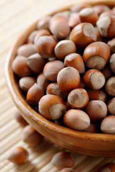 Wooden bowl full of Hazelnuts