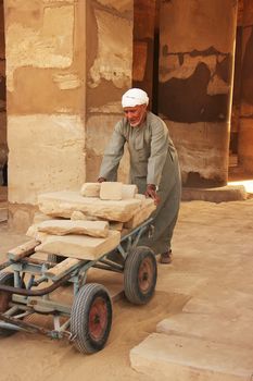 Local man working at Karnak temple complex, Luxor, Egypt