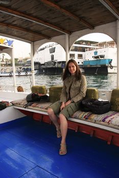 Young tourist taking felucca cruise on the Nile river, Luxor, Egypt