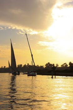 Felucca boats sailing on the Nile river at sunset, Luxor, Egypt