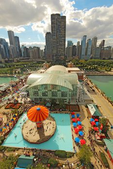 CHICAGO, ILLINOIS - SEPTEMBER 4: Aerial view of Navy Pier in Chicago, Illinois with a skyline background on September 4, 2011. The Pier is a popular destination with many attractions on Lake Michigan.