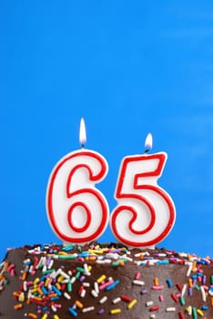 A number candle is lit in celebration of sixty five years.