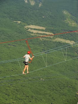 Man walking on a rope at Ai-Petri summit, Crimea peninsula, Ukraine