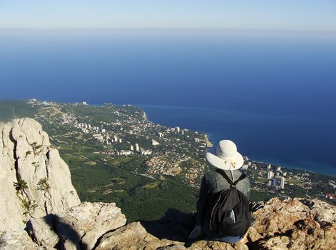 Young woman enjoying view from Ai-Petri summit, Crimea peninsula, Ukraine