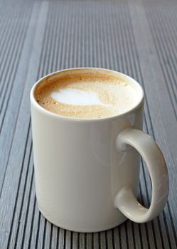 Hot coffee cup on a wooden table