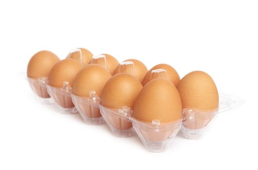 Eggs in the plastic package on white background