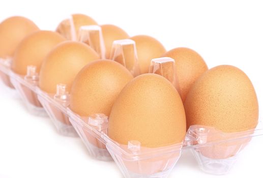 Eggs in the plastic package on white background