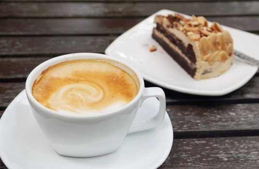 Cup of hot coffee on wooden table