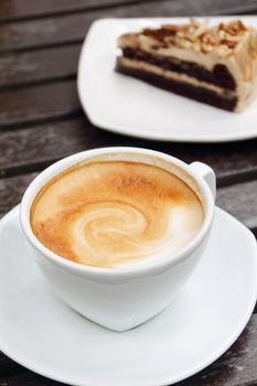 Cup of hot coffee on wooden table