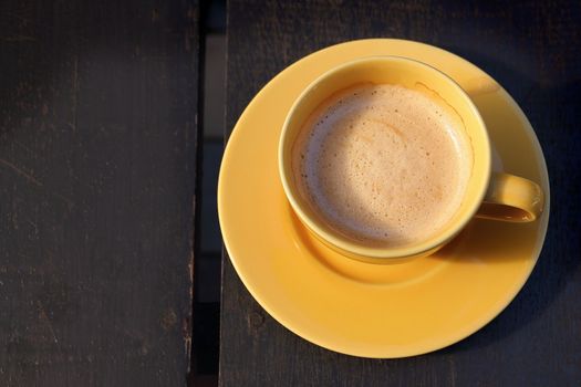 Cup of hot coffee on wooden table