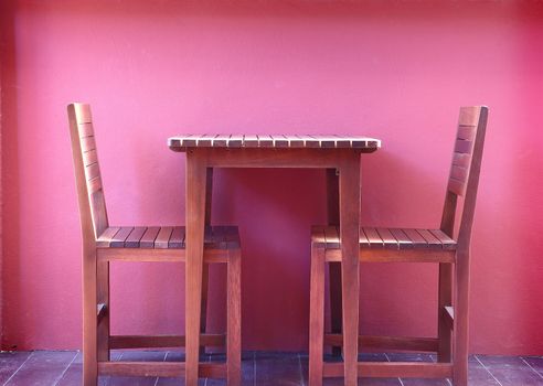 Wooden chairs with red wall