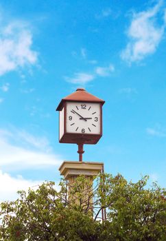 Clock tower in the park with blue sky background