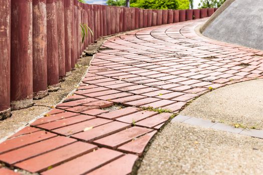 Sidewalk Curving walk  from  Paving Stones and wood walls garden