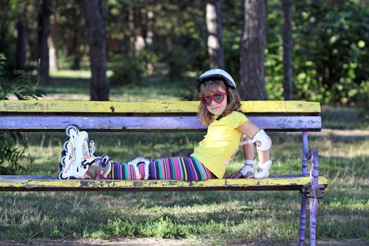 little girl with roller skates in park