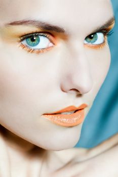 beauty portrait close up of a beautiful woman with orange make up