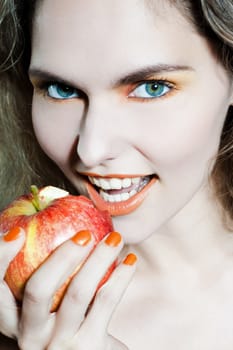 studio portrait of a beautiful woman holding apple fruit