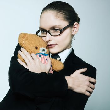 studio shot portrait of one caucasian young woman  holding a teddy bear