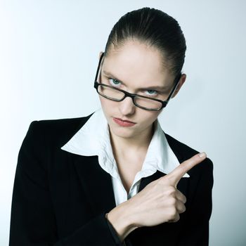 studio shot portrait of one beautiful business strict  nanny teacher woman pointing