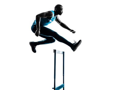 one african man hurdler running  in silhouette studio isolated on white background