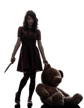 one caucasian strange young woman killer holding  bloody knife an teddy bear in silhouette white background