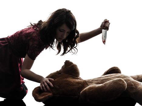 one caucasian strange young woman killing her teddy bear  in silhouette white background