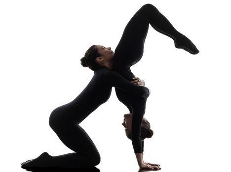 two women contortionist practicing gymnastic yoga in silhouette   on white background