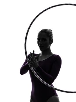 one caucasian woman exercising Rhythmic Gymnastics hula hoop  in silhouette studio isolated on white background