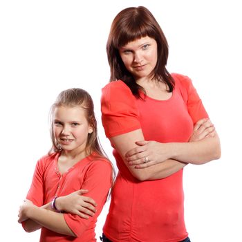 Mother and daughter standing with arms crossed on a white background