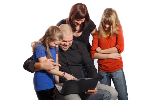 smiling happy family looking at computer on white background