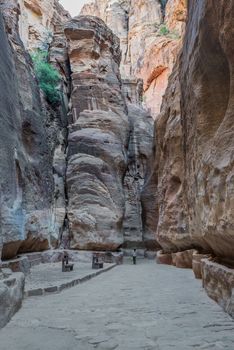 Nabatean, Jordan - May 11, 2013: one person walking on the siq path in nabatean city of  petra jordan on may 11th, 2013