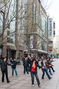 Shanghai, China - April 7, 2013: people exercising on nanjing road  at the city of Shanghai in China on april 7th, 2013