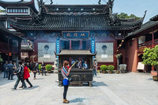 Shanghai, China - April 7, 2013: people praying in the city god temple Chenghuang Miao  at the city of Shanghai in China on april 7th, 2013