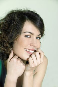studio shots portrait of a beautiful caucasian young smiling woman on green background