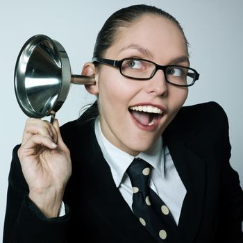 studio shot portrait of one caucasian curious business woman  hearing aid funnel curious spying gossip