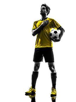one brazilian soccer football player young man standing in silhouette studio  on white background